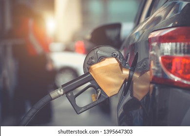 Car Gas Nozzle Auto Filling Refuel Fill Up With Premium Petrol Gasoline At Gas Station, Close Up. 
Gas Pump Nozzle In Fuel Tank Of Bronze Car, Refuel Petroleum To Vehicle At Gas Station.