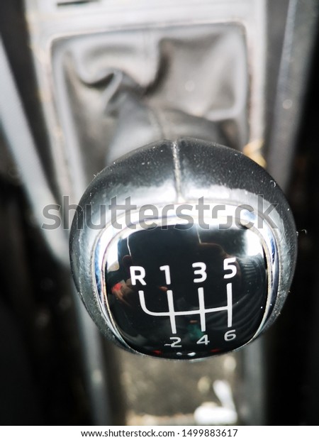 A car gear stick used to select different gears\
and speeds whilst driving