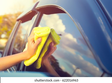 Car Glass Side Window Clean, Maintenance, Service Or Detailing. Wipe Polish By Asian Women Hand, Manual Worker, Yellow Microfiber Towel And Cleaner. To Remove Dust And Dirt. Result Gloss, Shine, Shiny