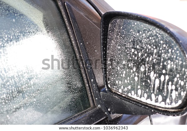 Car glass wash with spray cleaner, rear window of\
the car and mirror