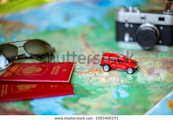 Car, glasses and camera on the world map