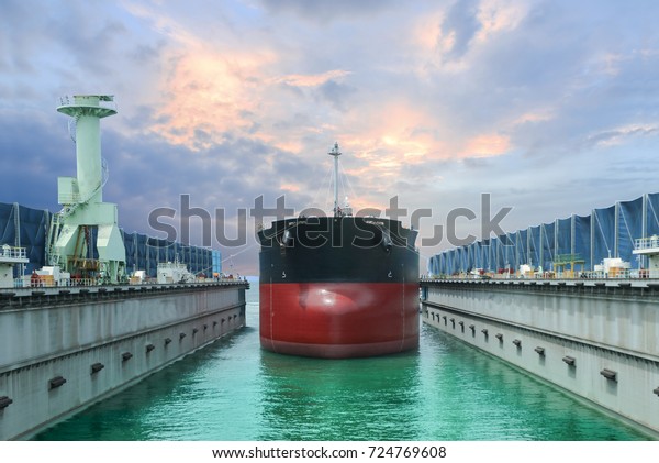 car go ship in floating dock under repair on\
blue sky background and\
monotone