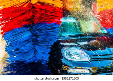 Car Going Through An Automated Car Wash Machine.