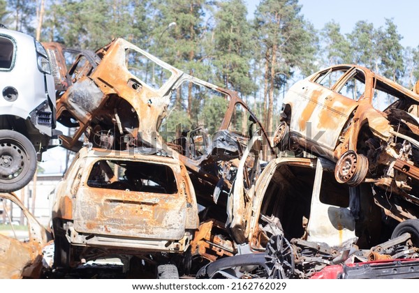 car graveyard.\
Burnt and blown up car. Cars damaged after shelling from russian\
invasion. War between Russia and Ukraine. Terror attack bomb shell.\
Disaster area irpin bucha.