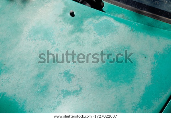 car green used peeling paint on grunge hood\
automobiles faded old by sun moon\
time