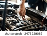 Car, hand and mechanic with person in workshop for maintenance, repair or service of engine. Auto, expert and inspection with vehicle engineer or technician checking dipstick for oil level in garage