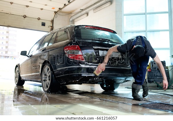 car hand\
washing, man washing car with\
sponge