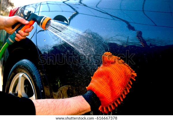 Car hand washing. A\
man washes his car. 