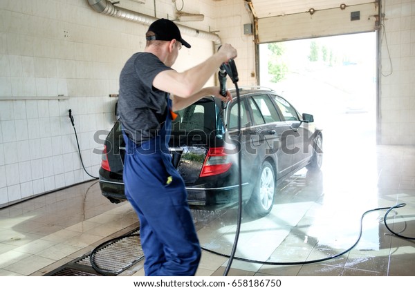car hand\
washing, man washing car with water\
pump