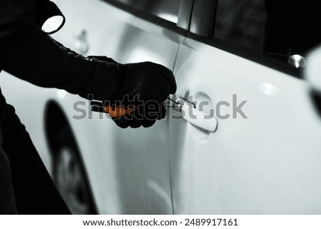 Car, handle and hands of criminal with tools for robbery, stealing and manipulation of lock mechanism. Parking lot, thief and crime for opening vehicle, illegal activity and sneaky person for mission