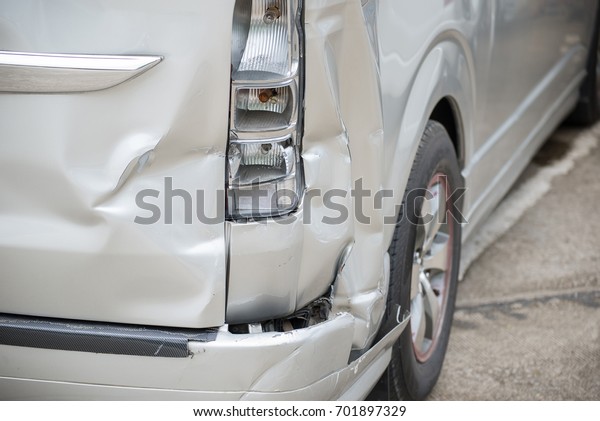 A car has a dented rear bumper after an\
accident/Damage/Car Accident.