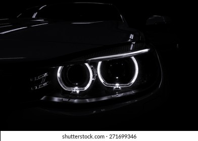 Car Headlight With Backlight On Black Background. Exterior Detail.