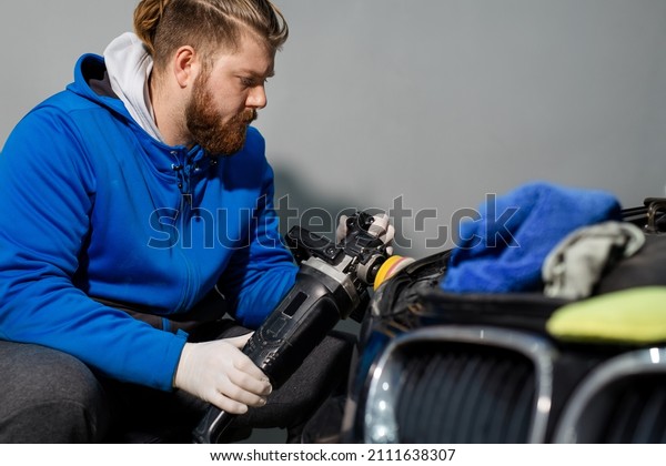 Car headlight cleaning with power buffer machine\
at service station