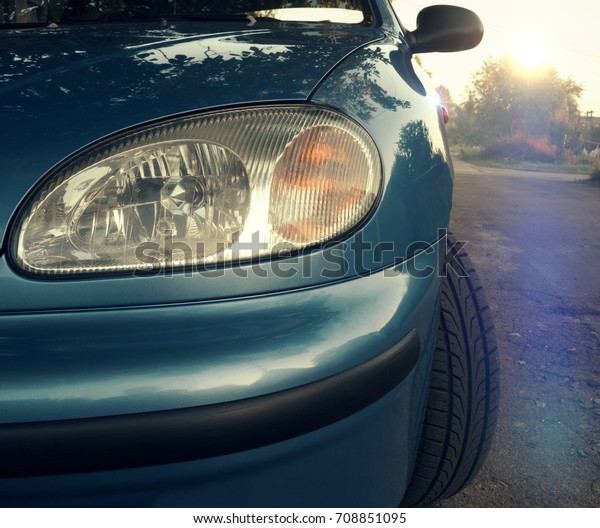 Car headlight close-up. Turn, stop and reverse\
signals on sunset