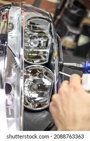 Car Headlight During Repair On The Desktop. Repair And Tuning Of Cars. Repair Of Headlights And Optics. Restoration Of Automotive Optics. Installation Of LED Lenses.