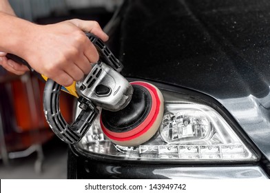 Car Headlights Cleaning With Power Buffer Machine At Car Service