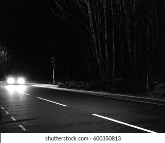 Car Headlights At Night On Deserted Country Road