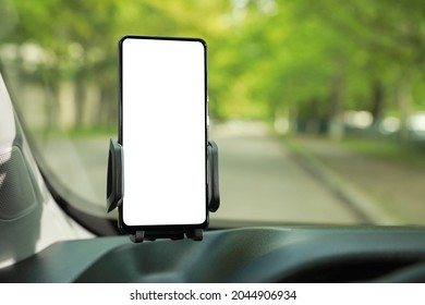 Car Holder With Modern Mobile Phone On Windshield Of Automobile. Mockup For Design