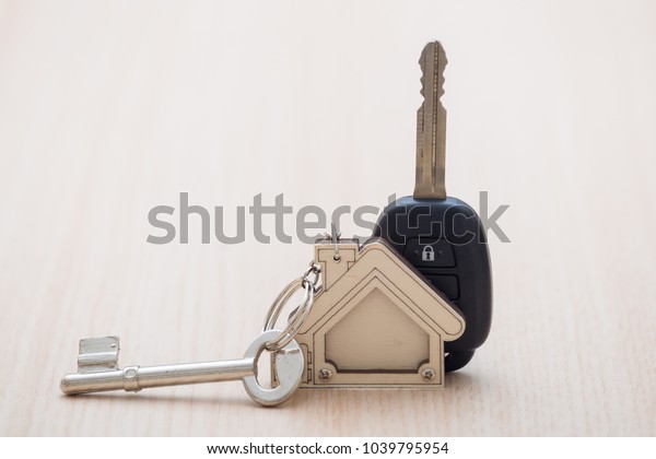 Car and\
house keys on table. Concept of\
success.