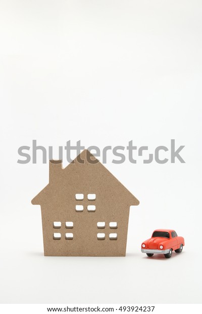 Car and house.\
Miniature car and house on\
white background.