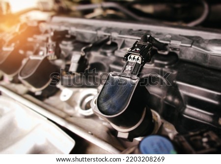 The car ignition coil electronic connector plug in the engine compartment has been removed, car repairing concept