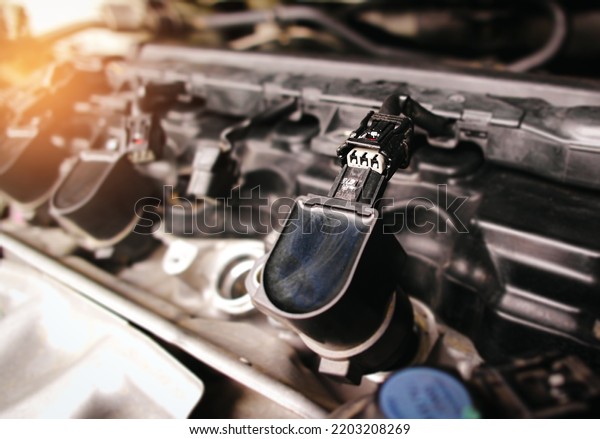 The\
car ignition coil electronic connector plug in the engine\
compartment has been removed, car repairing\
concept