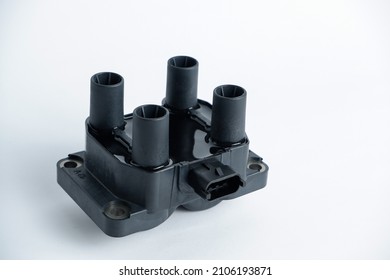 Car ignition coil on a white background close-up. Ignition coil for gasoline four-cylinder internal combustion engine