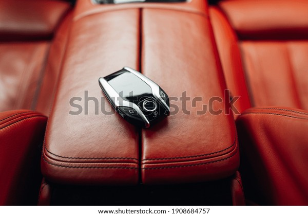Car ignition key at the armrest. Modern car keys inside\
new car 