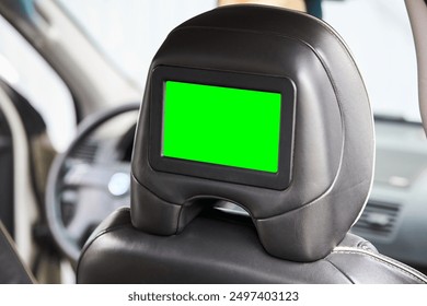 Car inside headrest screen mock up. Interior of prestige luxury modern car. One green display for back seats passenger with copy space and place for text design.