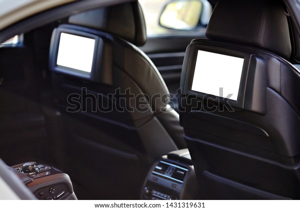 Car inside\
headrest screens mock up. Interior of prestige luxury modern car.\
Two white tv displays for back seats passengers with media control\
panel copy space and place for\
text.