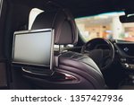 Car inside. Interior of prestige luxury modern car. Three TV displays for passenger with media control panel copy space and mock up.