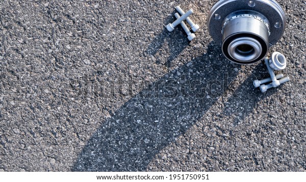 Car inspection. Auto motor\
mechanic spare or automotive piece on dark road asphalt background.\
Surface grunge rough of asphalt. Automobile engine\
service