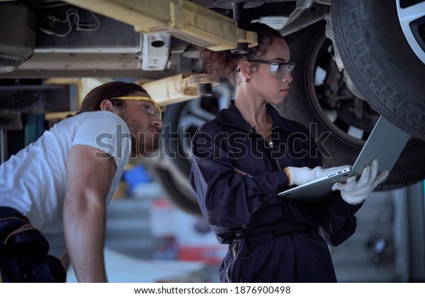 Car inspection with laptop by skilled\
technicians, technology\
concept