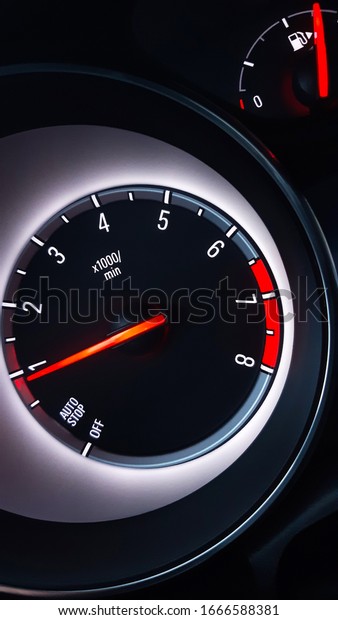 Car instrument cluster with tachometer showing\
engine idle speed