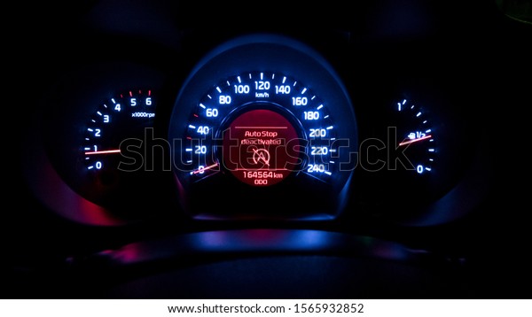 Car instrument panel with auto stop deactivated\
sing. Luminance of a car instrumental panel. Blue white and red\
colors. Sing of error or\
fault
