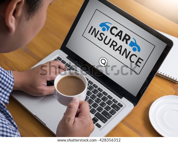CAR
INSURANCE Businessman at work. Close-up top view of man working on
laptop while sitting at the wooden desk ,
coffee