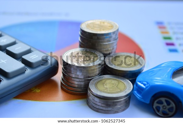 Car insurance. Cars with coins and\
calculator, finance and loan saving money\
concept.