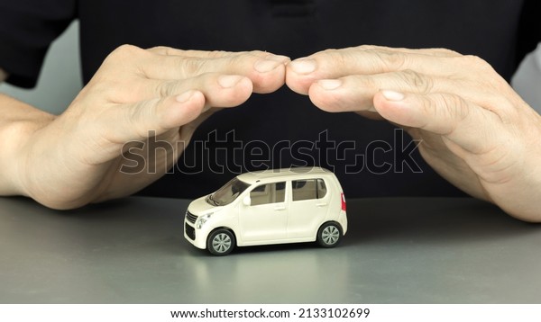 Car\
insurance concept.\
Hand as car \
protection.