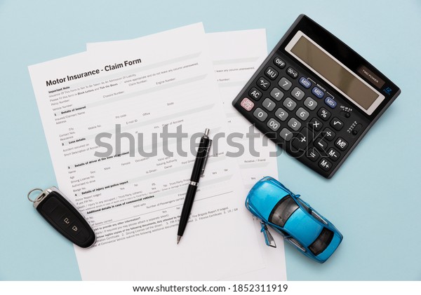 Car insurance, insurance contract and car keys\
on a blue background