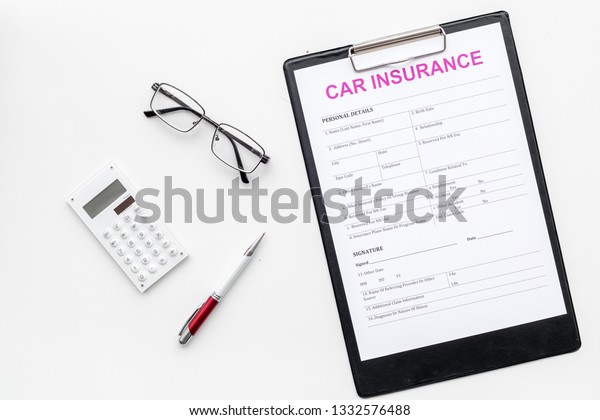 Car insurance form near glasses, calculator, pen\
on white background top\
view