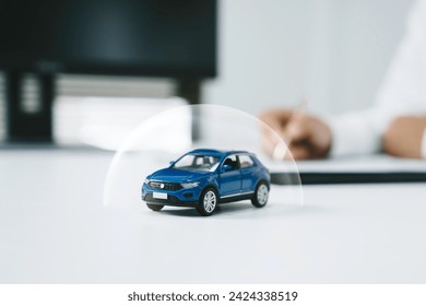 Car insurance, vehicle protection concept. protect blue toy car under a glass dome in concept car care, insurance, and repair coverage covered automobile for financial security. - Powered by Shutterstock