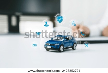 Car insurance, vehicle protection concept. Protect blue toy car under a glass dome with icon car care, insurance, and repair coverage covered automobile for financial security.