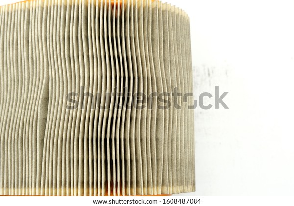 Car\
intake air filter with dust particles. Surface, structure and\
texture of fiber material of conditioning system element,\
protection for dust particles, copy space for\
text.