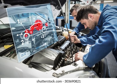 Car interface against team of mechanics working together - Shutterstock ID 303690821