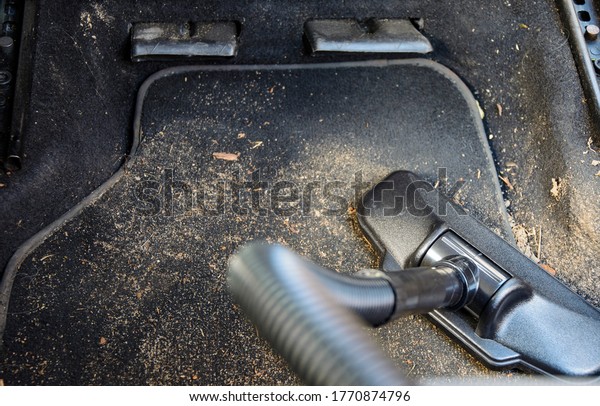 Car interior\
cleaning with a vacuum\
cleaner.