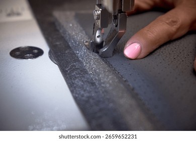 Car interior customization process in auto workshop. Close-up of hands working with tools, cutting, sewing, and modifying upholstery and car parts. Concept of vehicle tuning, craftsmanship