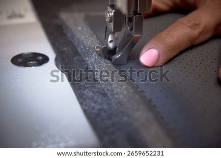 Car interior customization process in auto workshop. Close-up of hands working with tools, cutting, sewing, and modifying upholstery and car parts. Concept of vehicle tuning, craftsmanship