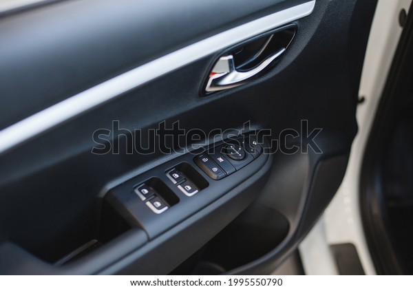 Car\
interior detail. Closeup of controls on the\
door