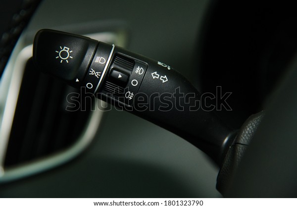 Car interior\
details close-up. The light knob in the car. Multifunction\
headlight console control switch\
knob