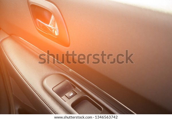 Car interior details of door handle\
with windows controls. Car window controls and\
details.